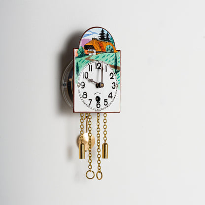 Wanduhr "Schwarzwaldhaus",  Bogenschild aus Emaille, Maße: 50 x 75 mm, Eintagewerk